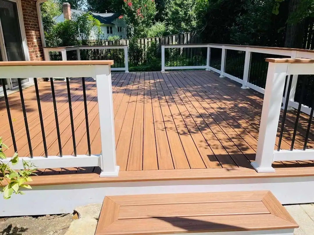 Beautiful wooden deck with white railing, perfect for outdoor entertaining and relaxation.