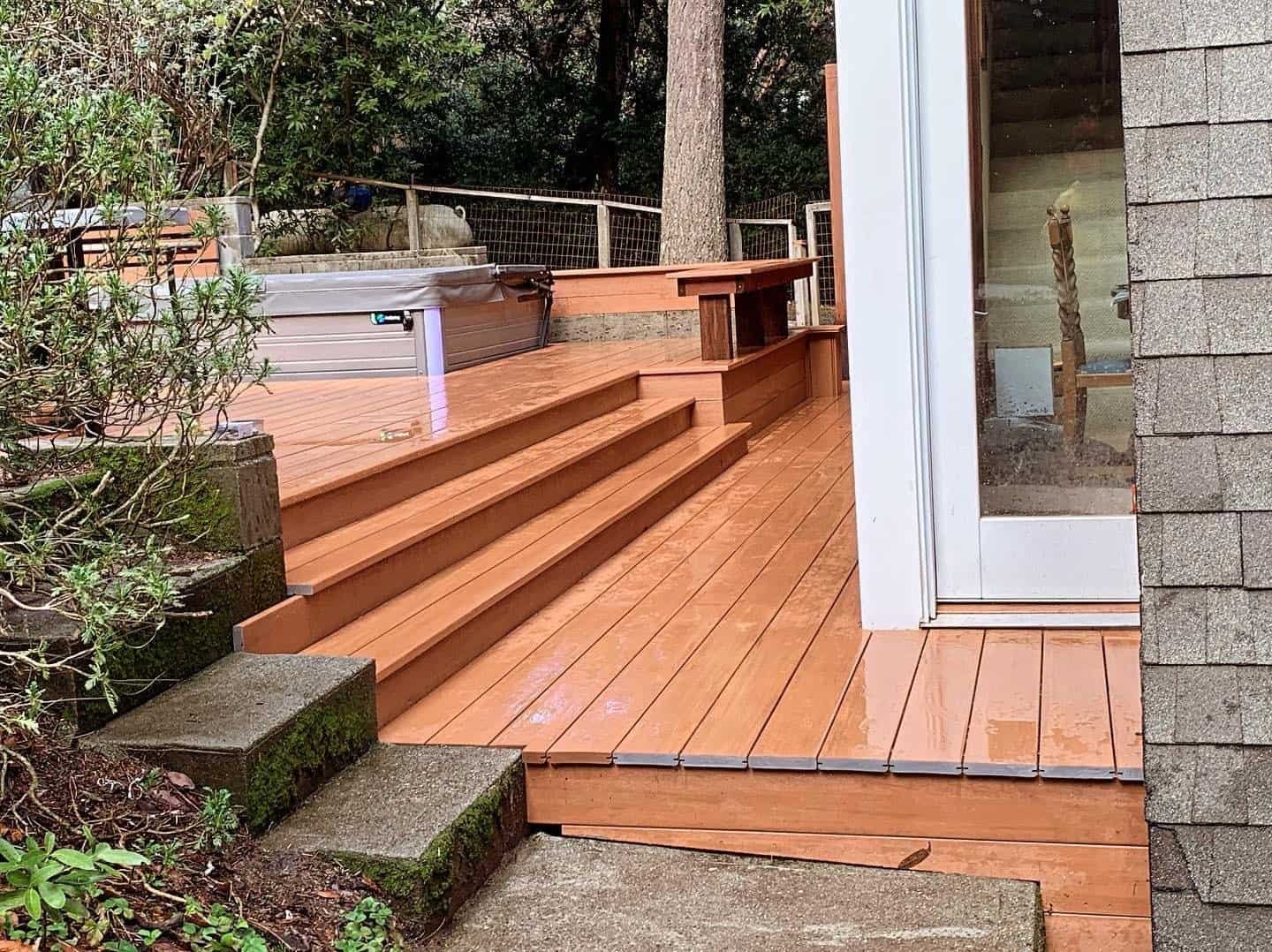 Wooden deck with steps leading to backyard, showcasing quality craftsmanship.
