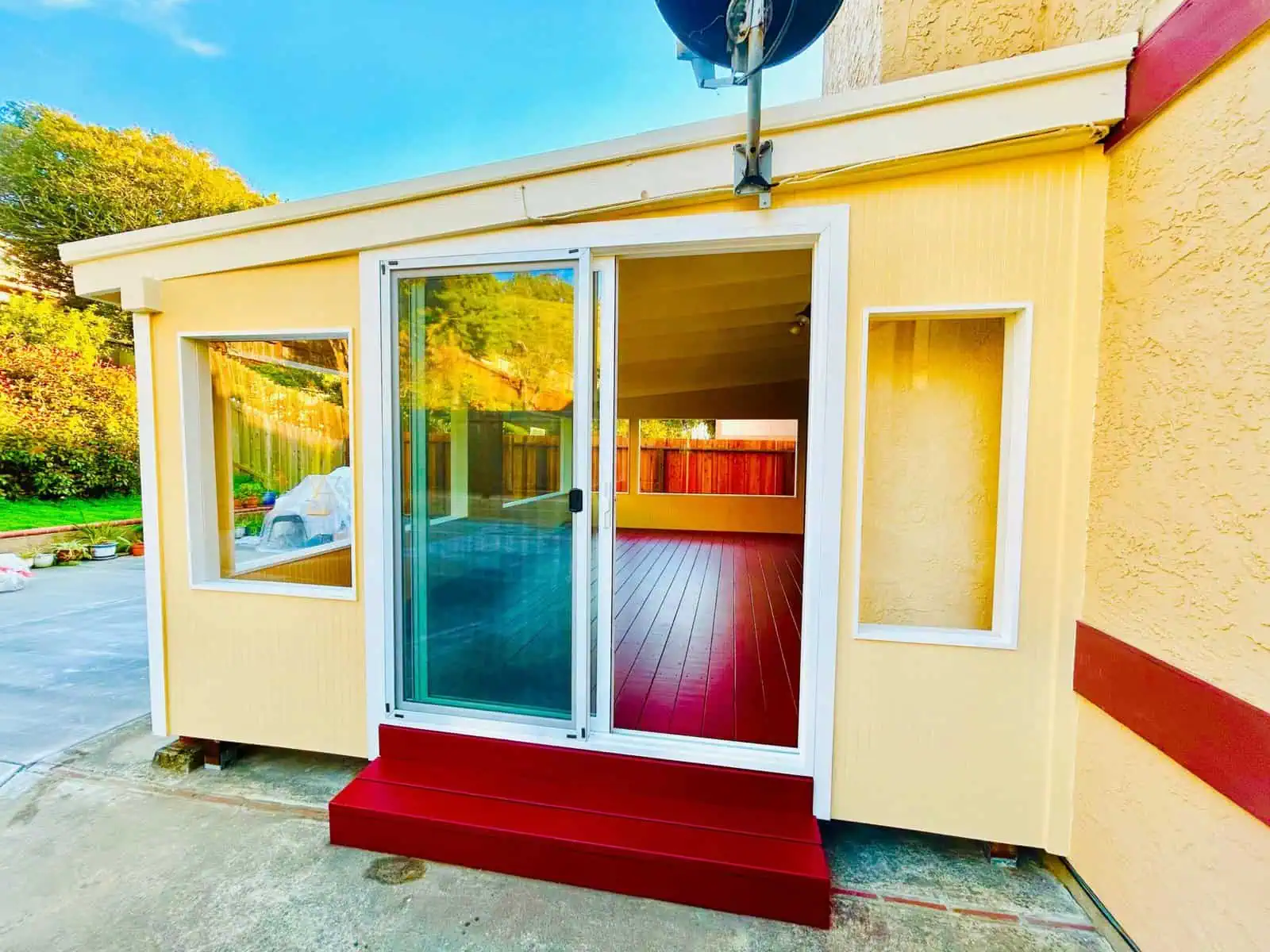 Sunroom with large glass sliding door and windows, perfect for outdoor views and natural light.